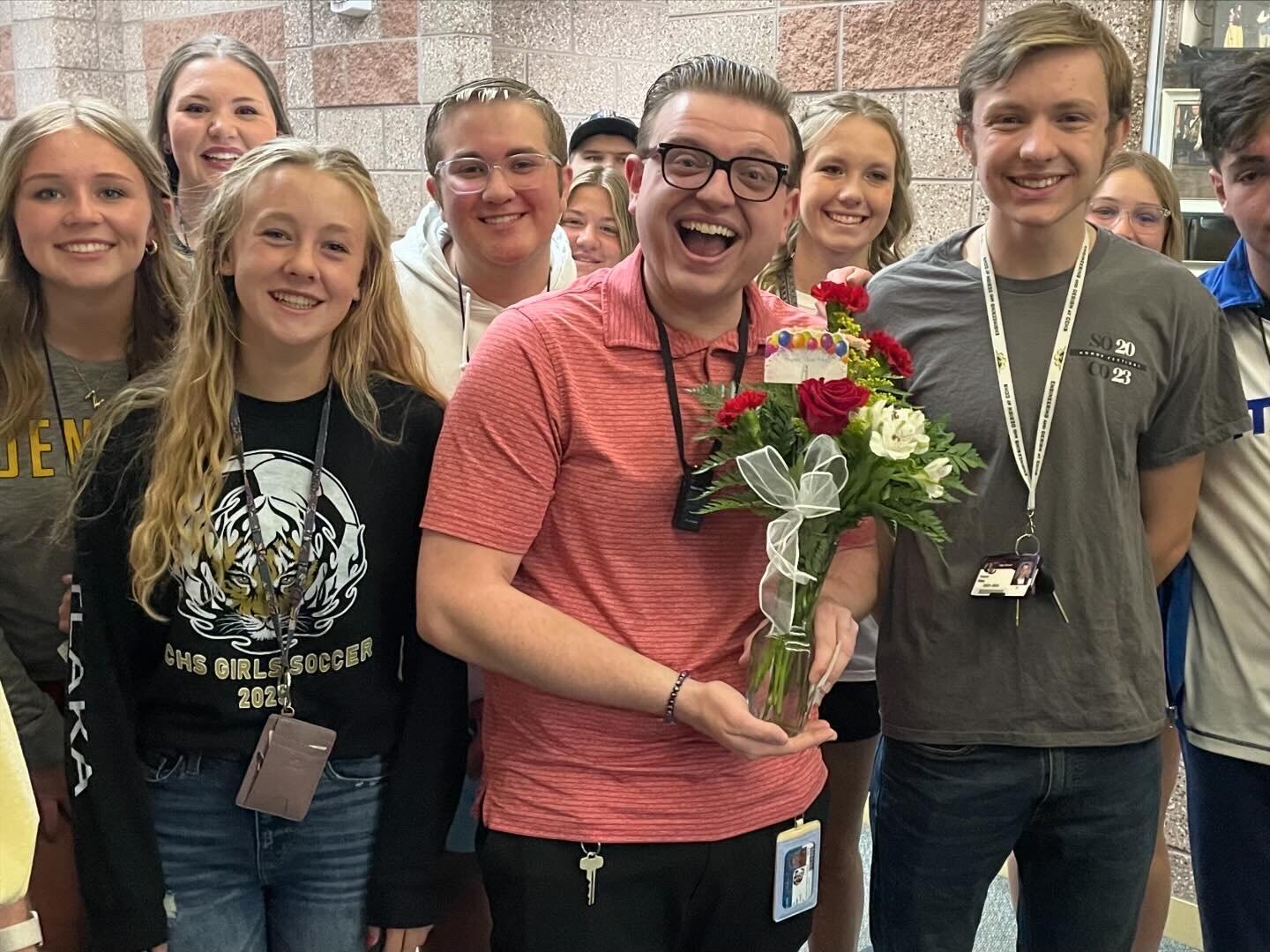 Mr. Ryan holding flowers with Student Council Members