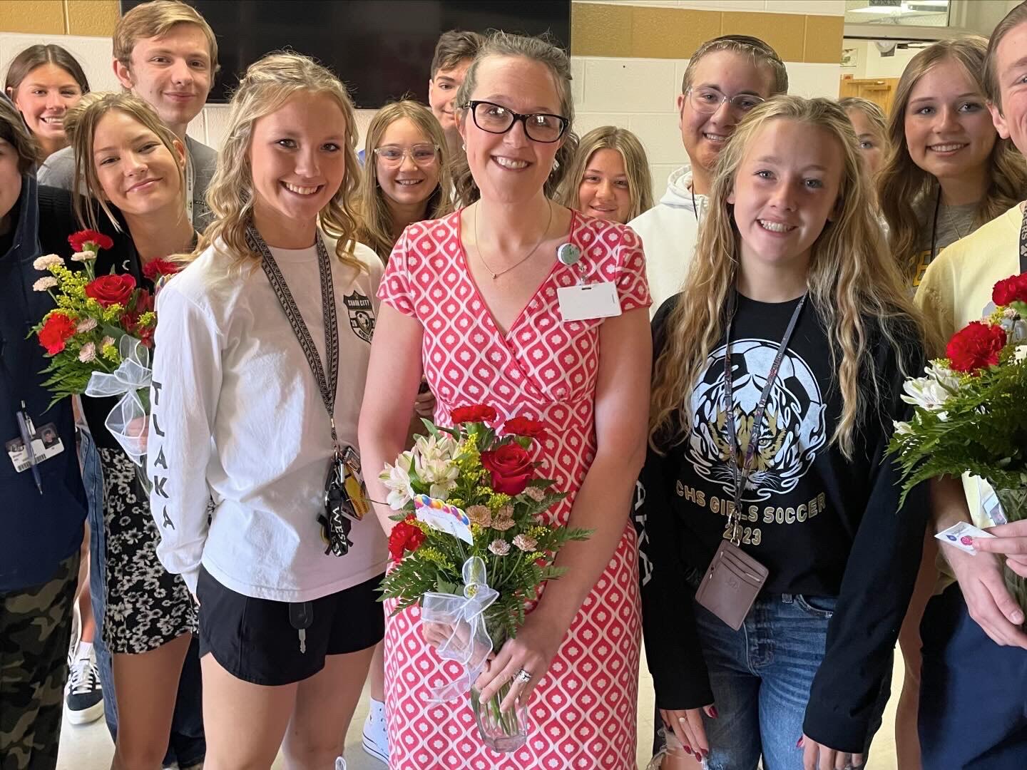 Mrs. Weber holding flowers with Student Council Members